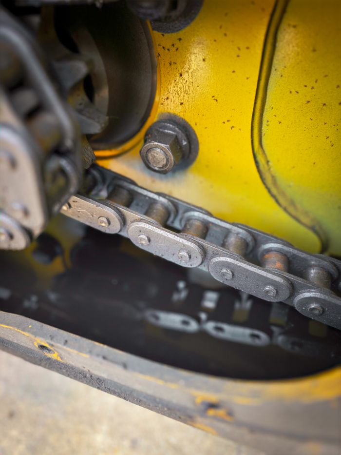 Services Detailed view of a machinery chain and gears with reflections and oil.
