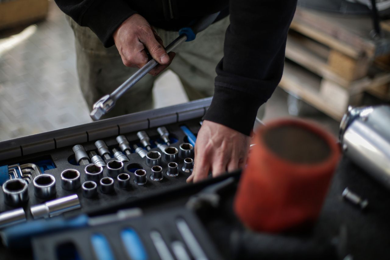 The Art of Drawing Readers In: Your attractive post title goes here From above view of crop unrecognizable mechanic in workwear choosing metal sockets for ratchet while repairing vehicle in modern workshop